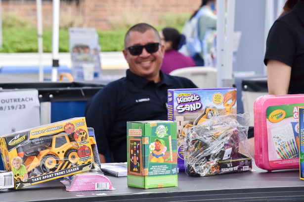 A Social Services Agency employee distributes toys to children at an event