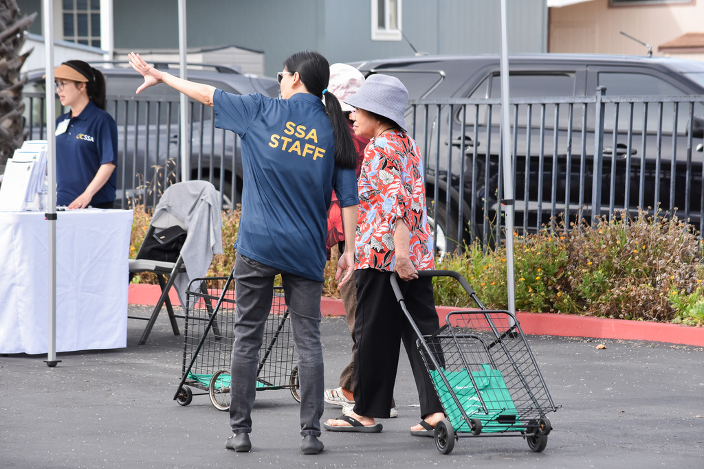 SSA staff helps a client at a community event