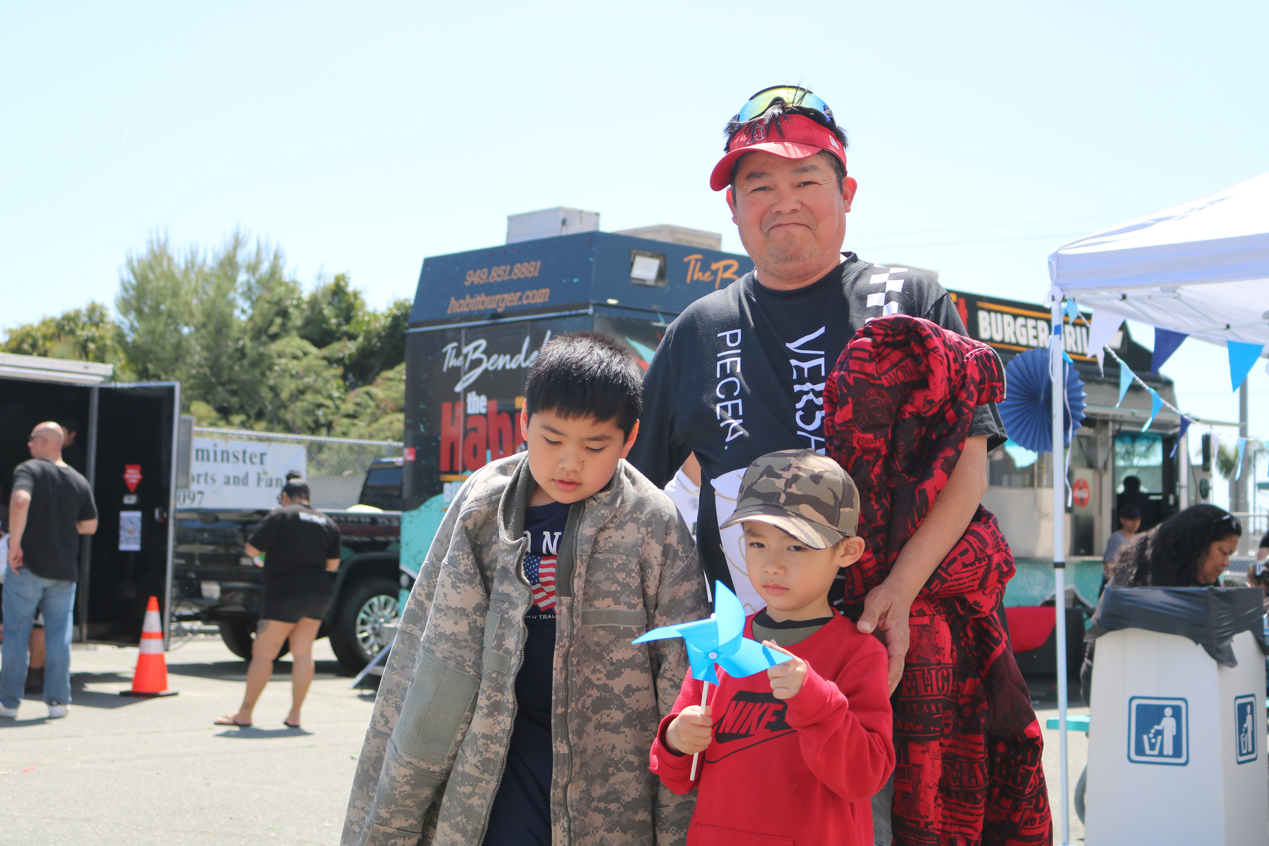 A family poses at a Families and Communities Together event