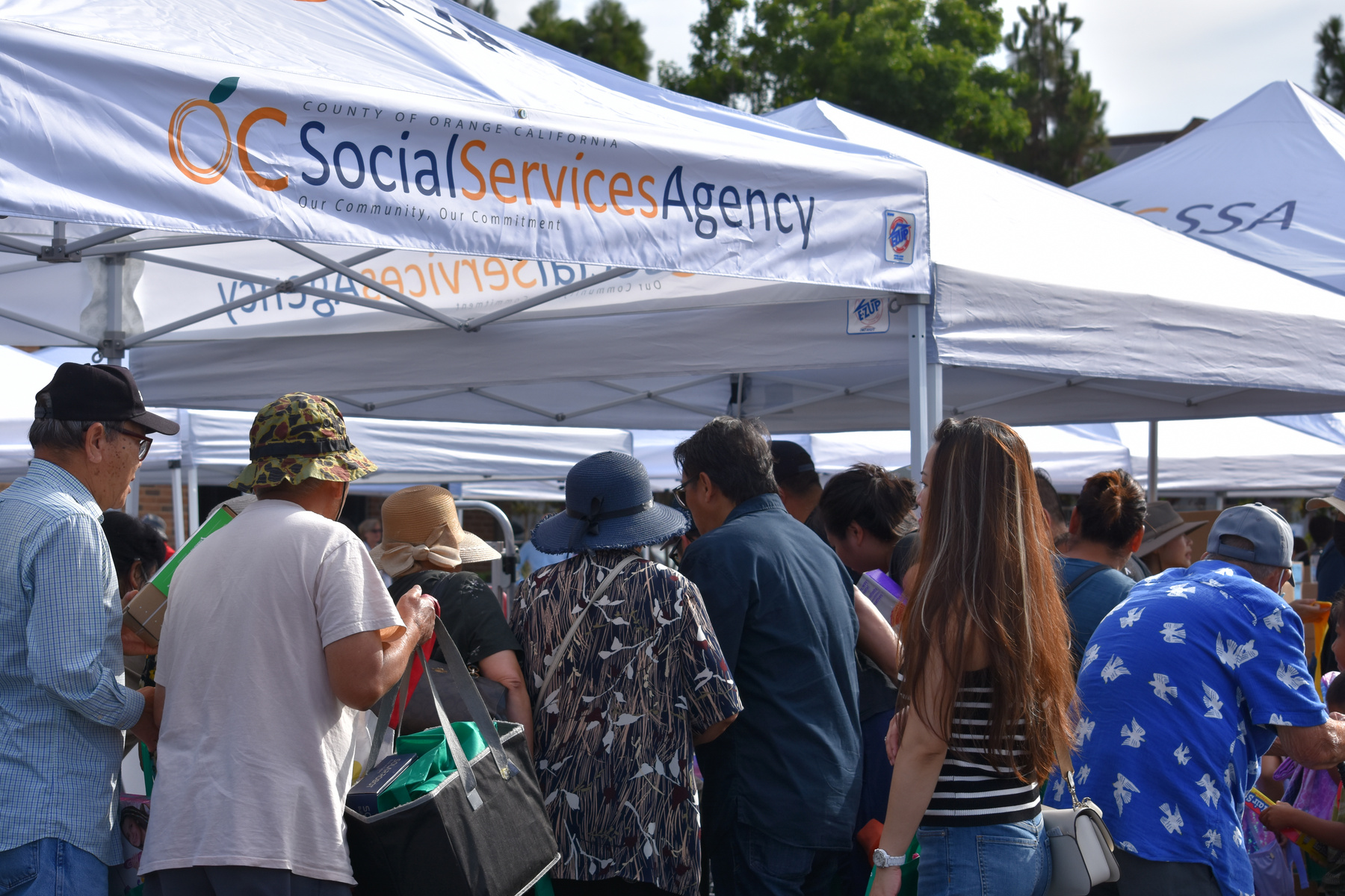 Attendees wait in line at a community resource fair event